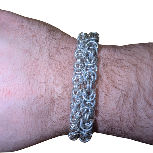 Two handmade sterling silver Byzantine bracelets worn on a wrist, showing thickness and structure